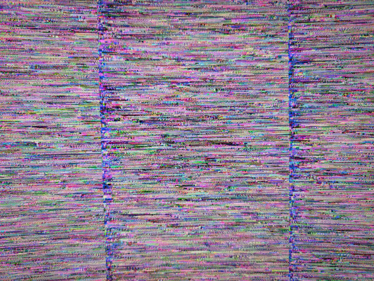 A close-up photo of a monitor screen showing rainbow-colored horizontal scanlines.
