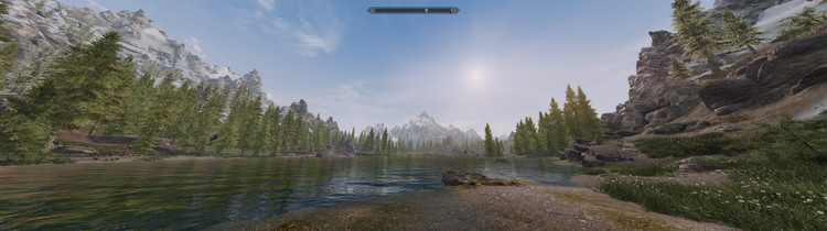 A screenshot of Skyrim at 32:9 showing a river surrounded by mountains.